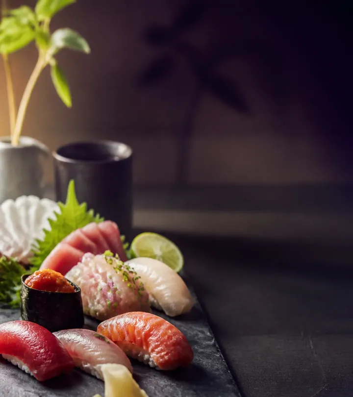 Seasonal omakase platter with nigiri and sashimi on dark slate